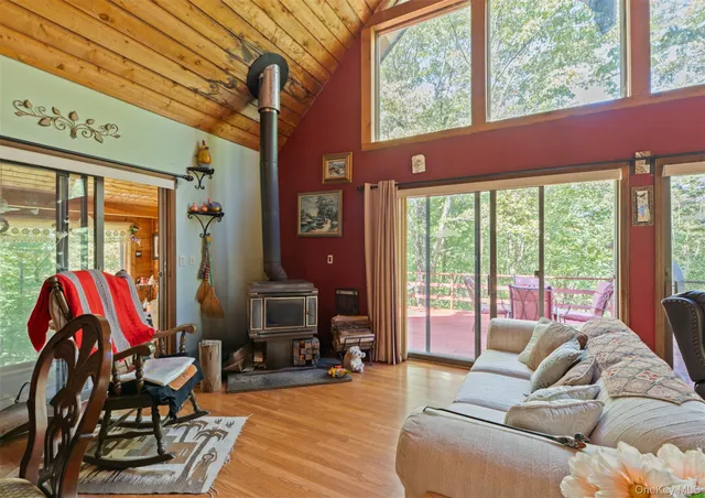 a bedroom with a bed and large windows