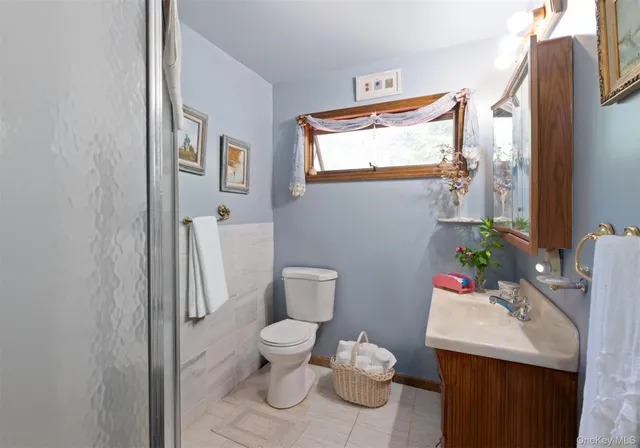 a bathroom with a toilet a sink and a window