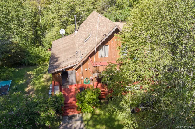 a aerial view of a house with large trees