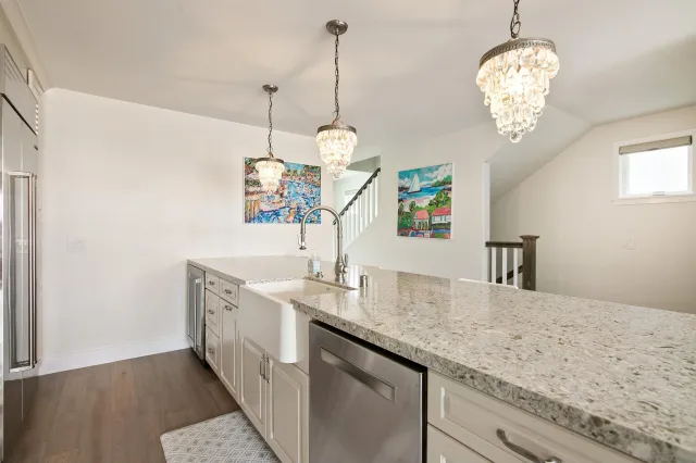 a kitchen with center island table and chairs