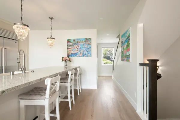 a dining room with furniture a chandelier and wooden floor