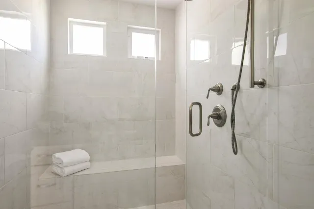 a view of a roof deck with couches under an umbrella