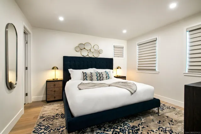 a bedroom with bed and wooden floor