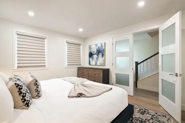 a bedroom with a bed and wooden floor