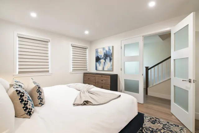 a bedroom with a bed and wooden floor