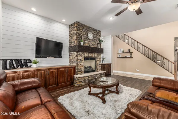 a living room with furniture kitchen view and a large window