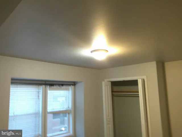 a view of kitchen with stainless steel appliances granite countertop cabinets and a window