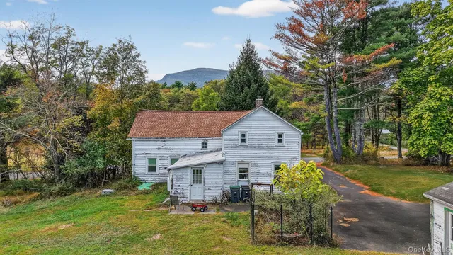 a aerial view of a house with a yard table and chairs