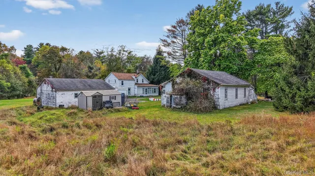 a aerial view of a house with a big yard plants and large trees