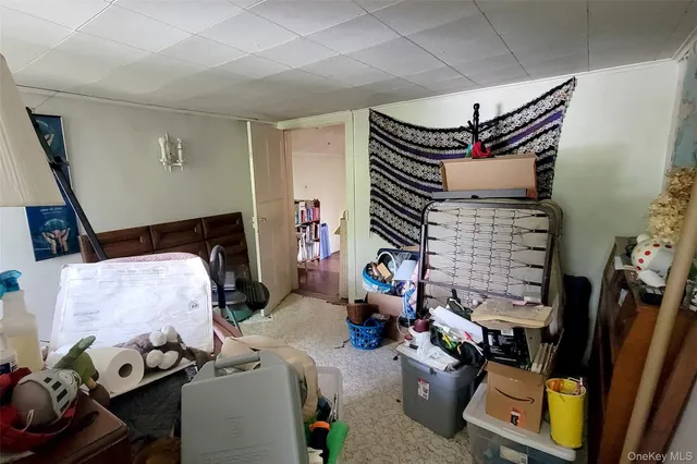 a bedroom with furniture and a flat screen tv