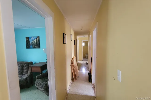a view of a hallway with bathroom and a bathroom