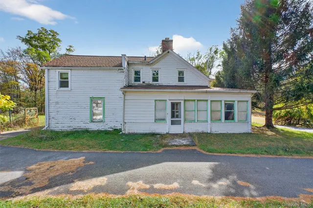 a front view of a house with a garden and yard