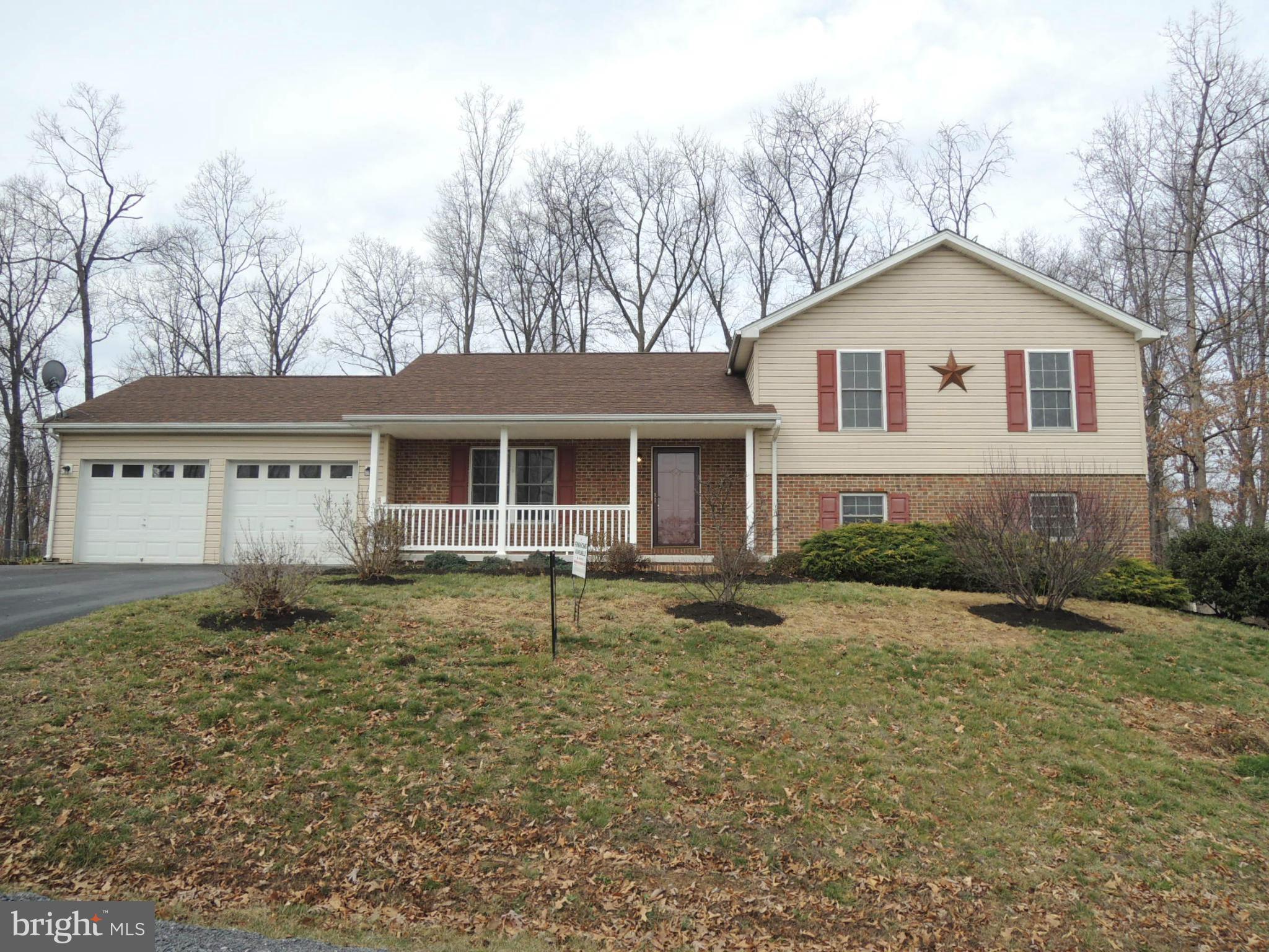 39 Raft Court Inwood, WV 25428 - Photo 1 of 30 a front view of a house with a yard and garage