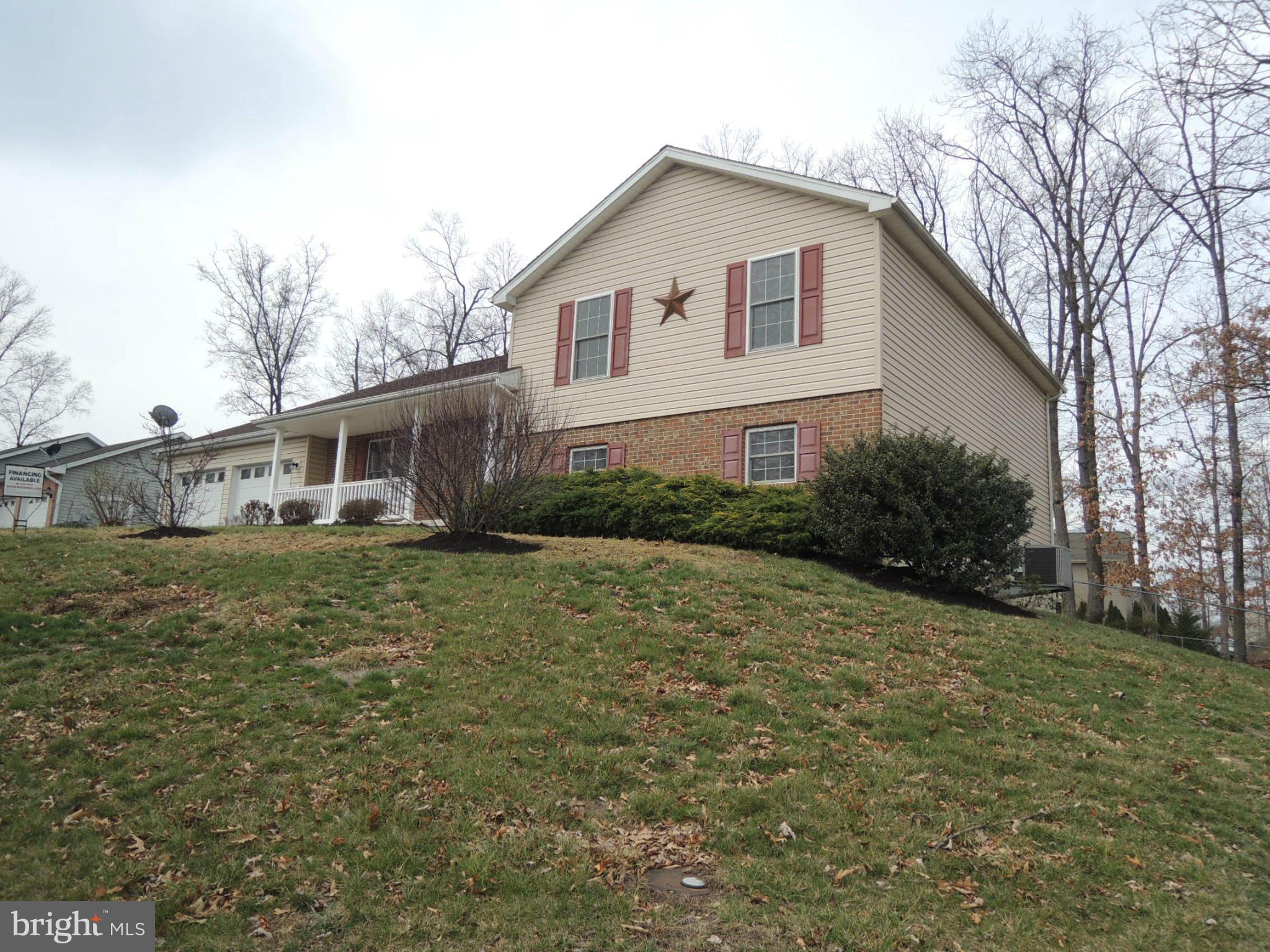 39 Raft Court Inwood, WV 25428 - Photo 3 of 30 a front view of a house with garden
