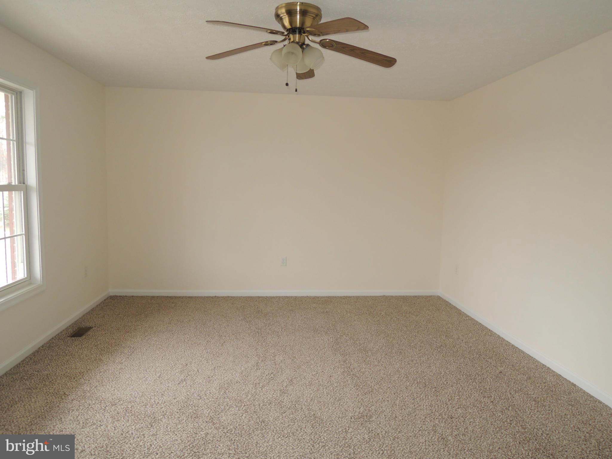 39 Raft Court Inwood, WV 25428 - Photo 6 of 30 an empty room with a window and a fan
