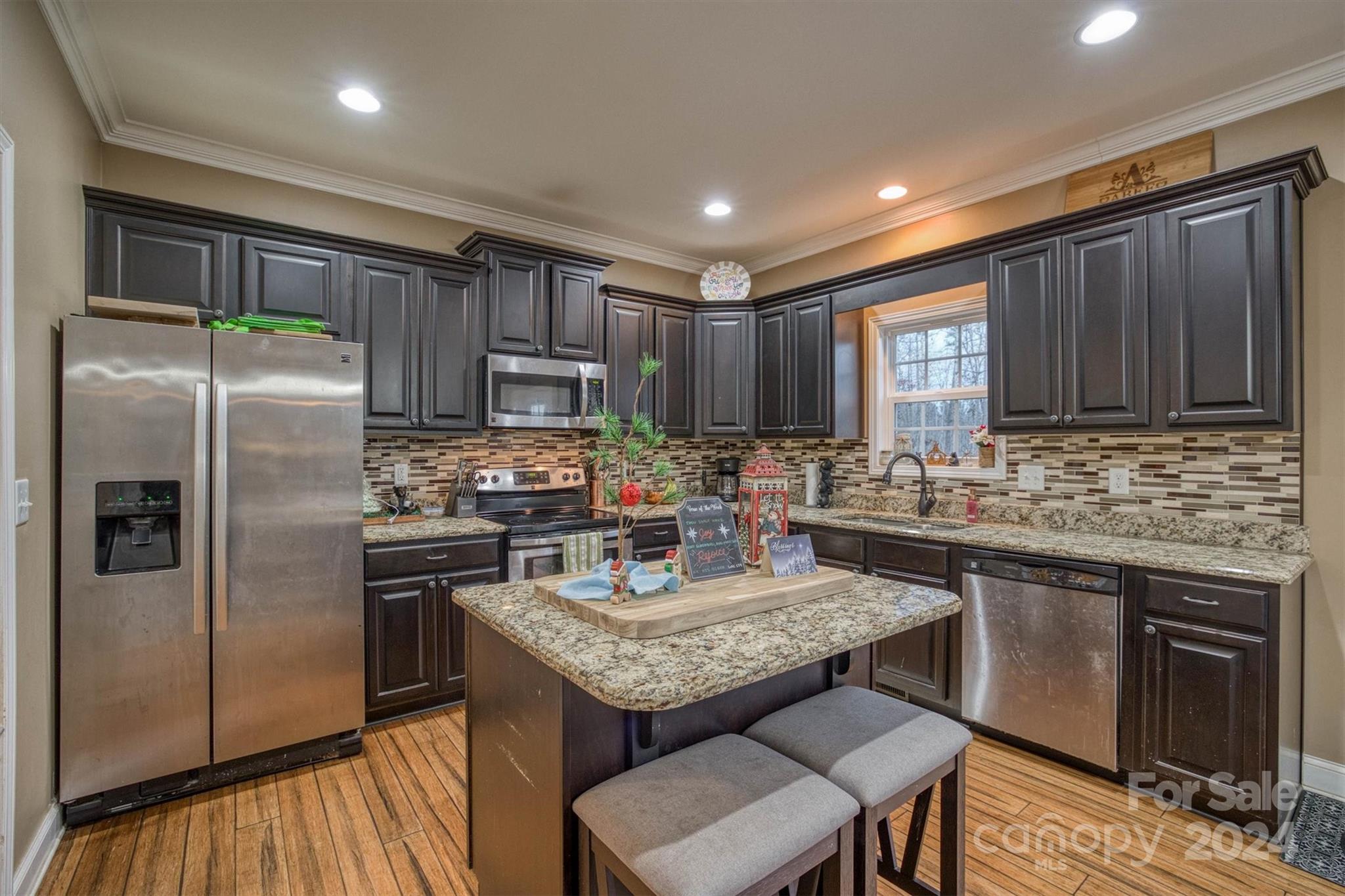 7838 Oren Stephens Road Hickory, NC 28602 - Photo 11 of 31 a kitchen with kitchen island granite countertop stainless steel appliances and wooden cabinets