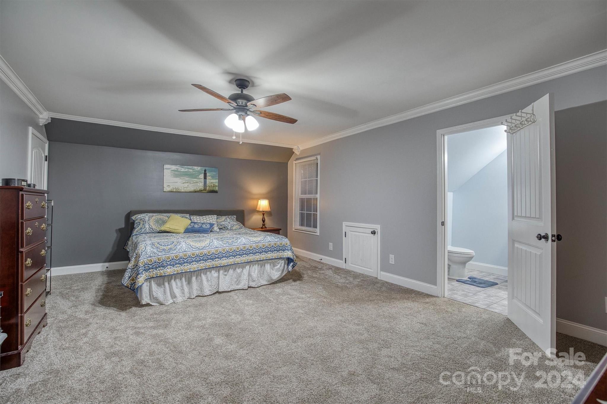 7838 Oren Stephens Road Hickory, NC 28602 - Photo 21 of 31 a spacious bedroom with a bed and a chandelier