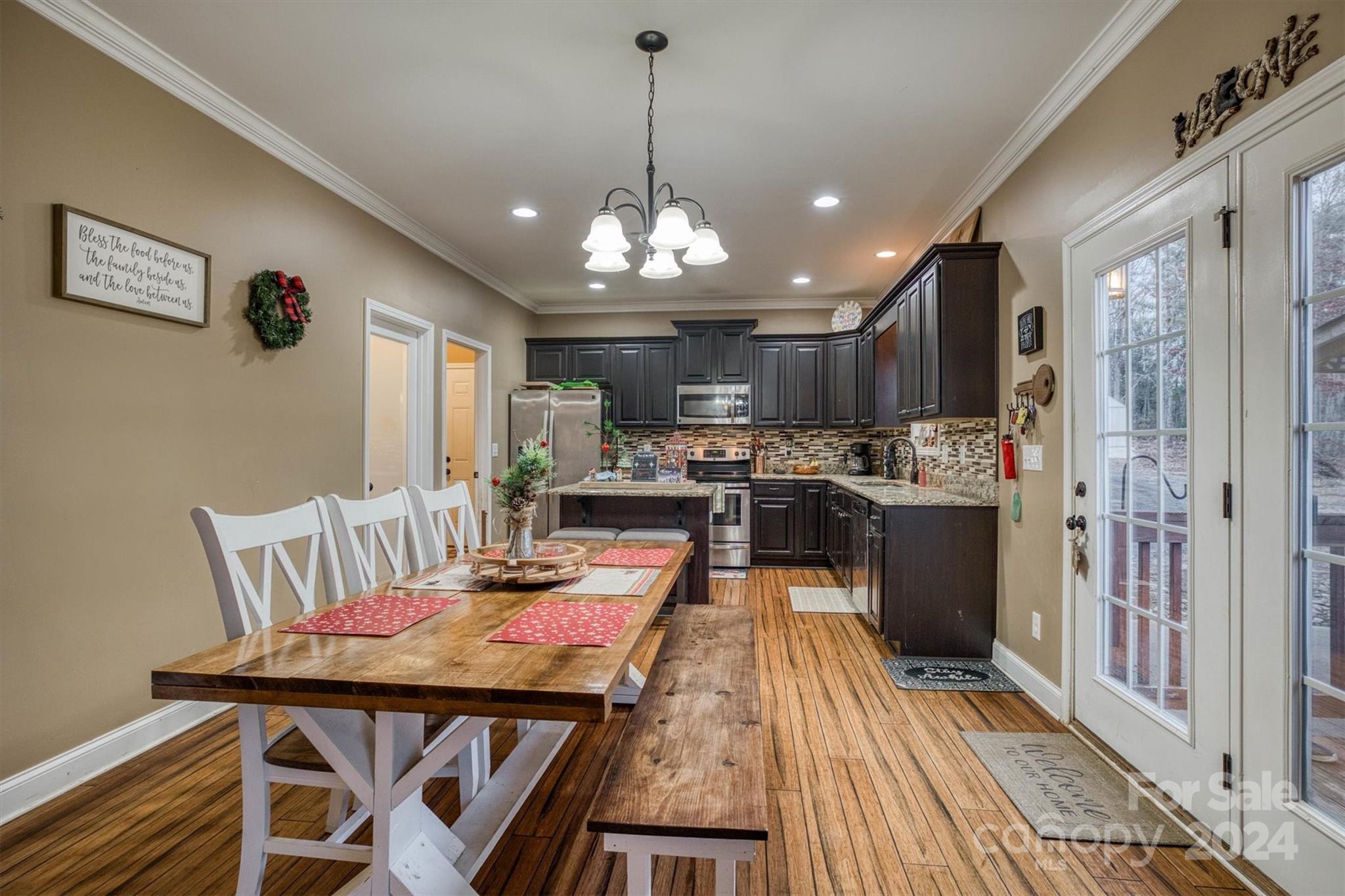 7838 Oren Stephens Road Hickory, NC 28602 - Photo 10 of 31 a dining room with furniture a chandelier and wooden floor