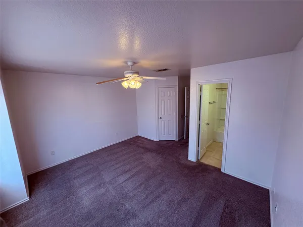 a view of an empty room and a window