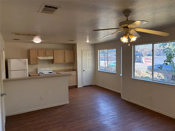 a kitchen with stainless steel appliances granite countertop a stove a sink and a refrigerator
