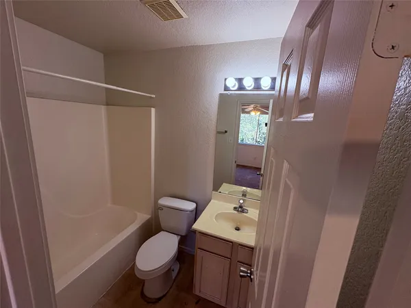 a white toilet sitting next to a shower curtain