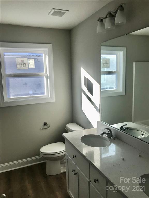 1007 3rd Street Spencer, NC 28159 - Photo 9 of 12 a bathroom with a toilet sink and mirror