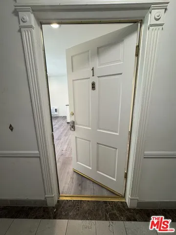 an empty room with wooden floor and a window