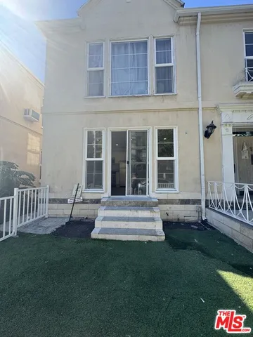 a view of kitchen with wooden floor and electronic appliances