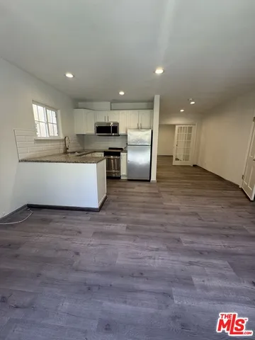 a view of kitchen and wooden floor