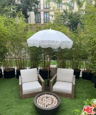 a view of a patio with couches table and chairs and a yard
