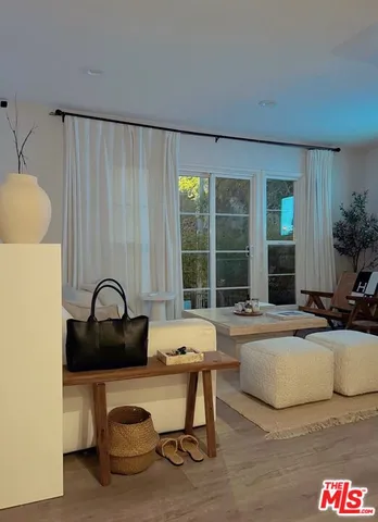 a living room with furniture a window and kitchen view