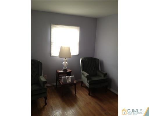 23 Baldwin Road Edison, NJ 08817 - Photo 14 of 19 a living room with furniture and a mirror