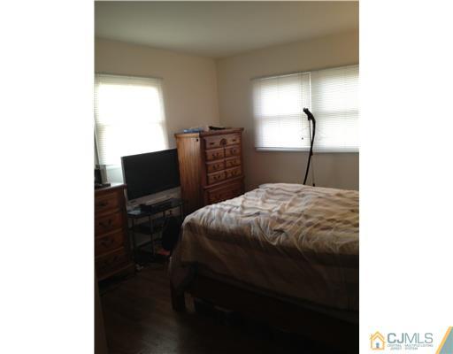 23 Baldwin Road Edison, NJ 08817 - Photo 15 of 19 a bedroom with a bed and a flat screen tv