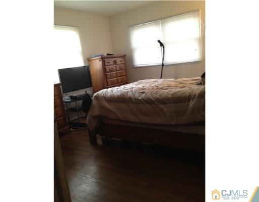 23 Baldwin Road Edison, NJ 08817 - Photo 16 of 19 a bed sitting in a bedroom next to a window