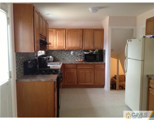 23 Baldwin Road Edison, NJ 08817 - Photo 5 of 19 a kitchen with stainless steel appliances granite countertop a refrigerator a stove a sink and a microwave