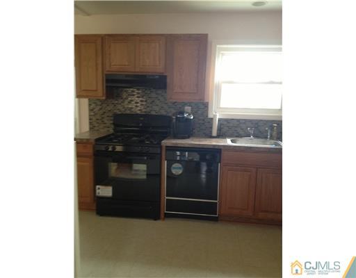 23 Baldwin Road Edison, NJ 08817 - Photo 6 of 19 a kitchen with a stove and a microwave