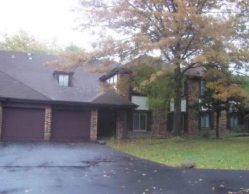a front view of a house with a yard and a garage