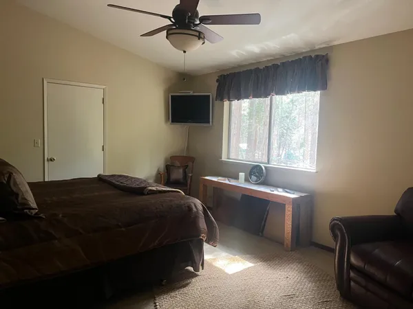 a bedroom with furniture and a window