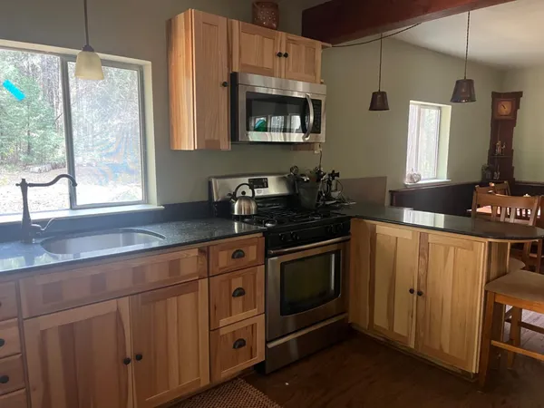a view of a house with a yard and wooden fence