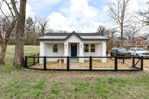 a view of a house with a yard and sitting area