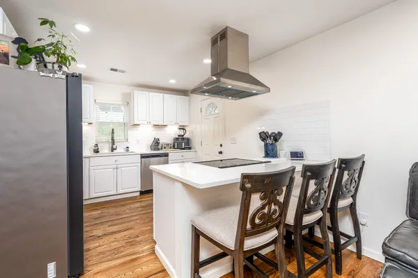 a kitchen with a table and chairs in it