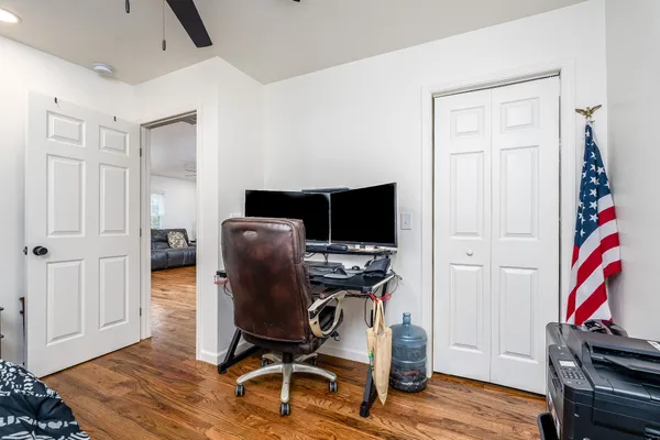 a view of a workspace with furniture and wooden floor
