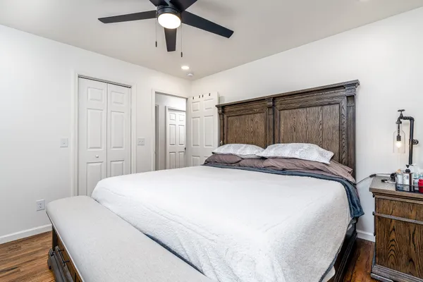 a bedroom with a bed and a chandelier