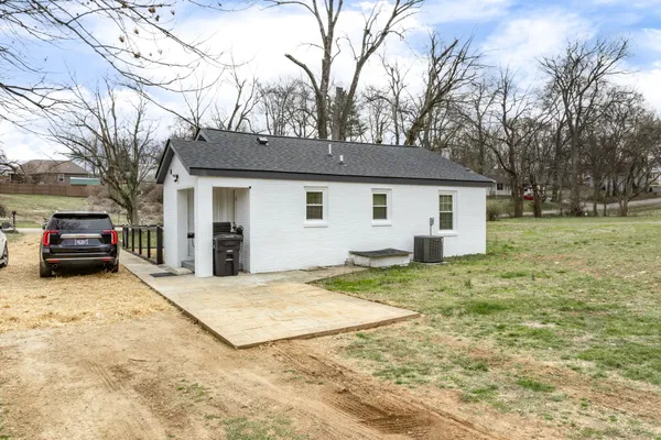 a view of a house with a yard covered in snow