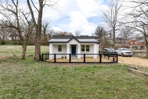 a view of a house with a yard and sitting area