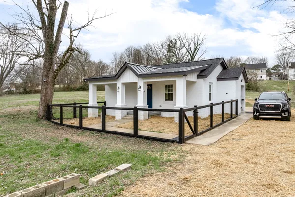 a view of a house with wooden fence