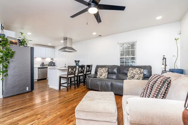 a living room with furniture and kitchen view