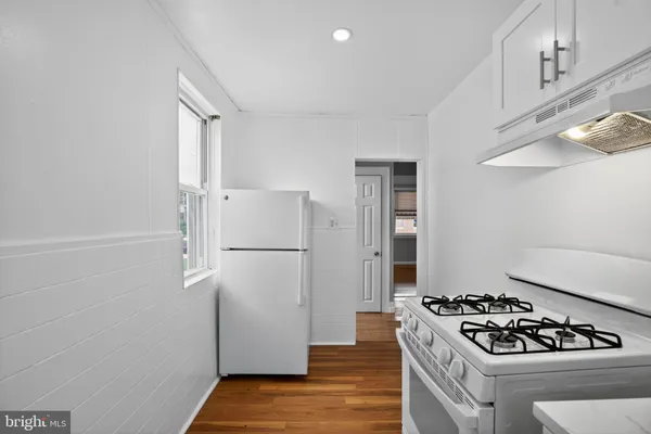 a kitchen with a stove and a refrigerator