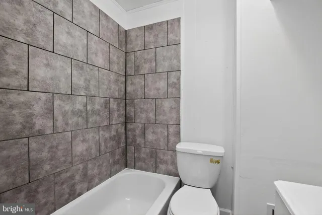 a bathroom with a toilet and sink