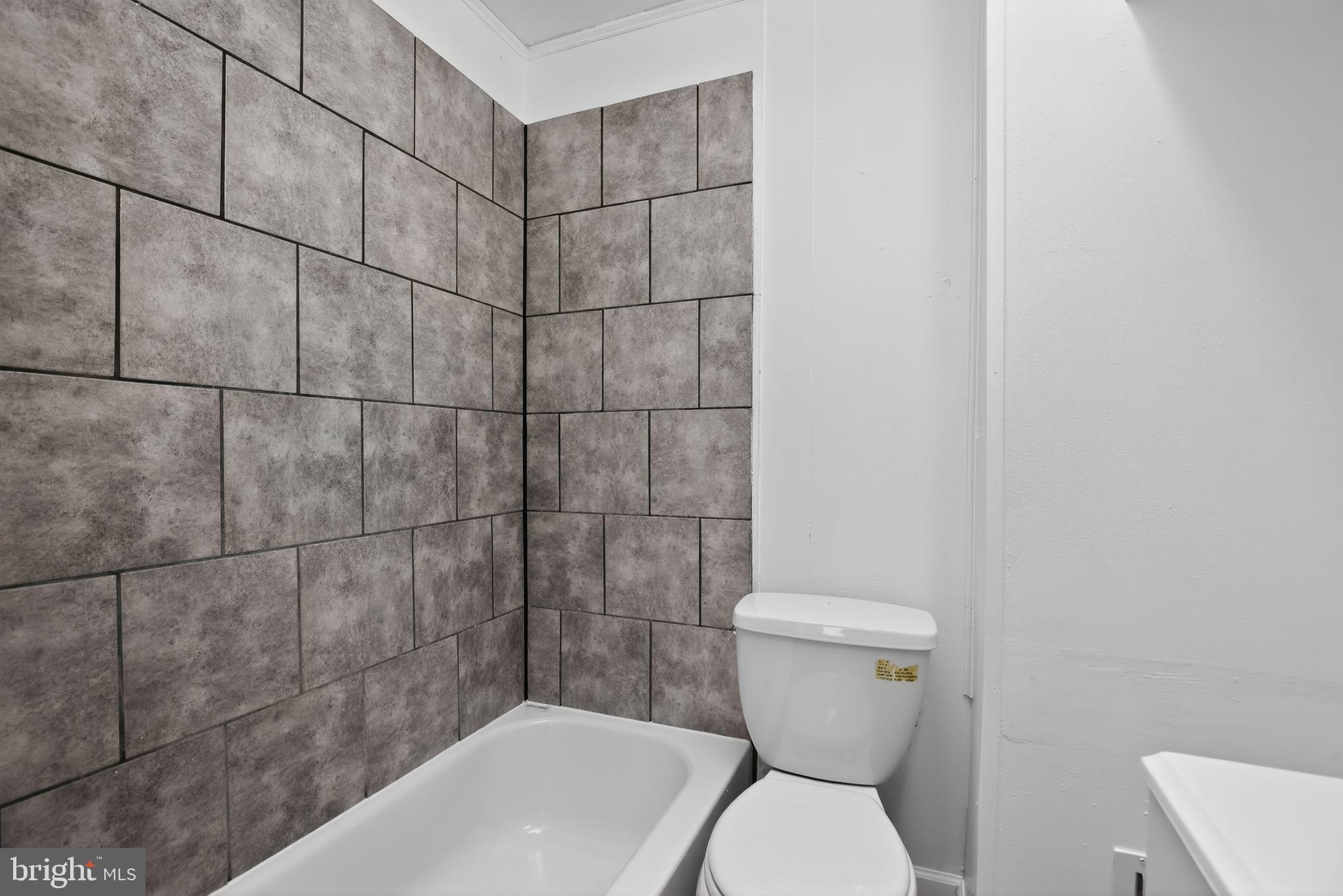 5446 Narcissus Avenue, Unit 2 Baltimore, MD 21215 - Photo 17 of 18 a bathroom with a toilet and sink